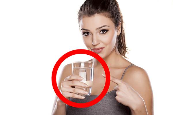 Woman holds a glass of water from Deep Space